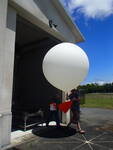 thmbnail image for NOAA_MaunaLoa_2018_Carryingballoonouttheshed.JPG